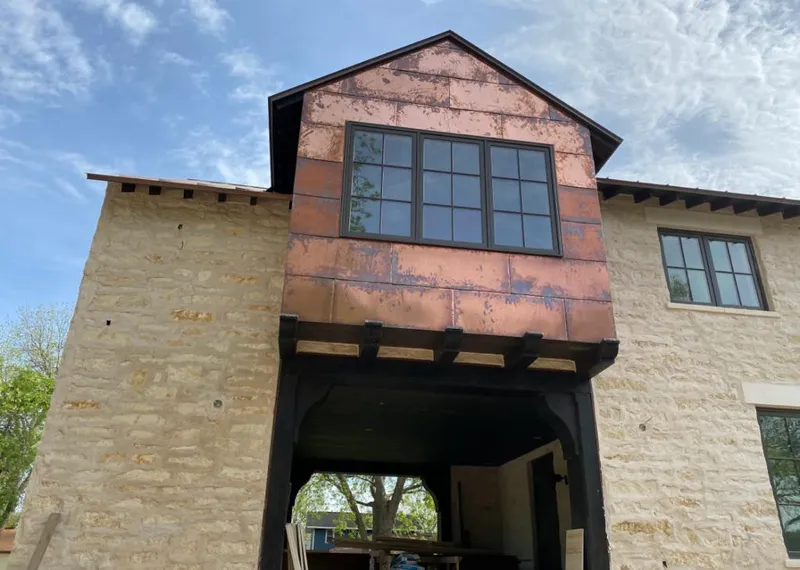 Copper metal panel facade on a stone building for Skylight Installation in Skaneateles