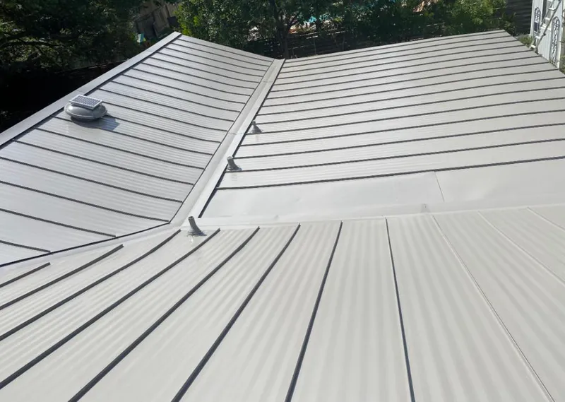 Solar attic fan installed on a metal roof for Roof Ventilation in Skaneateles