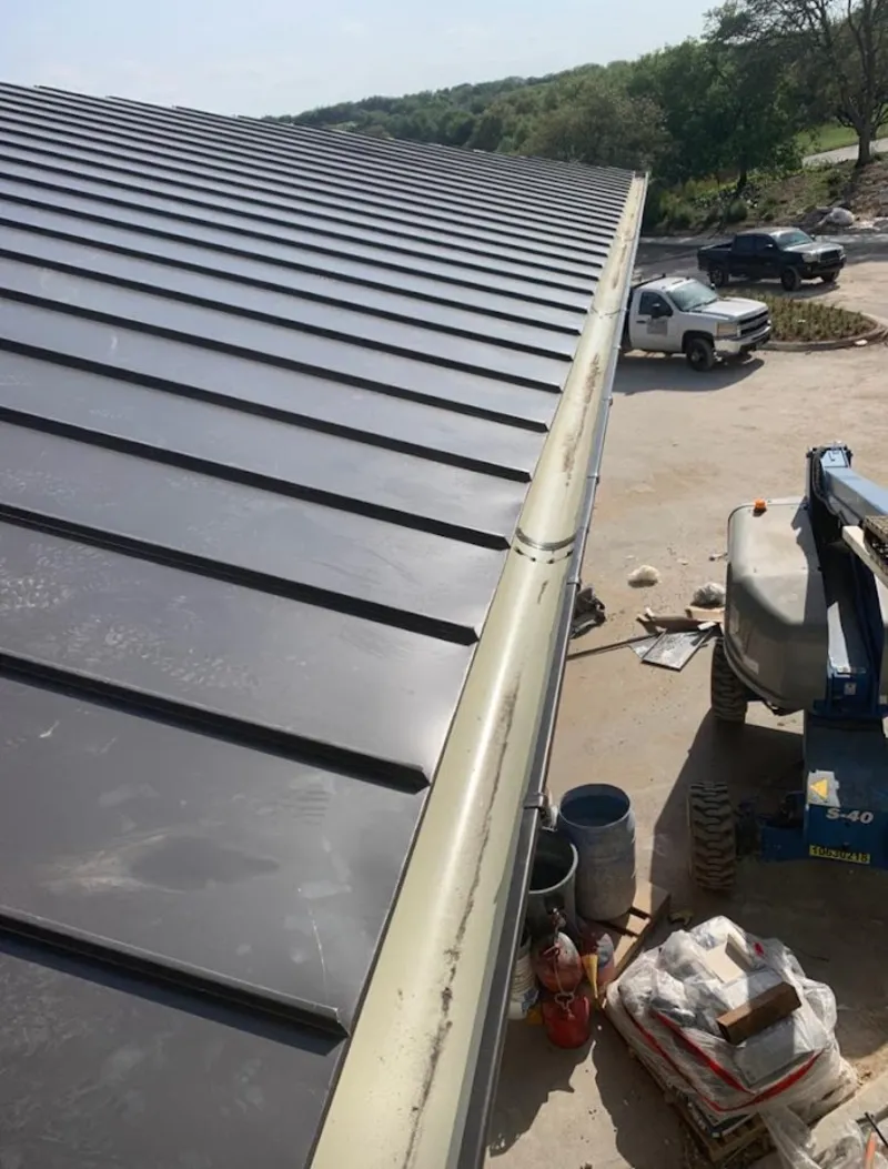 Standing seam panel and gutter detail on a metal roofing jobsite in Skaneateles